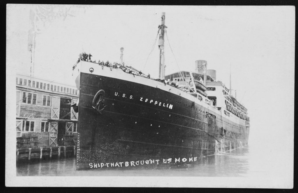 Photo of USS Zeppelin with words "The Ship that brought us home" written at bottom.